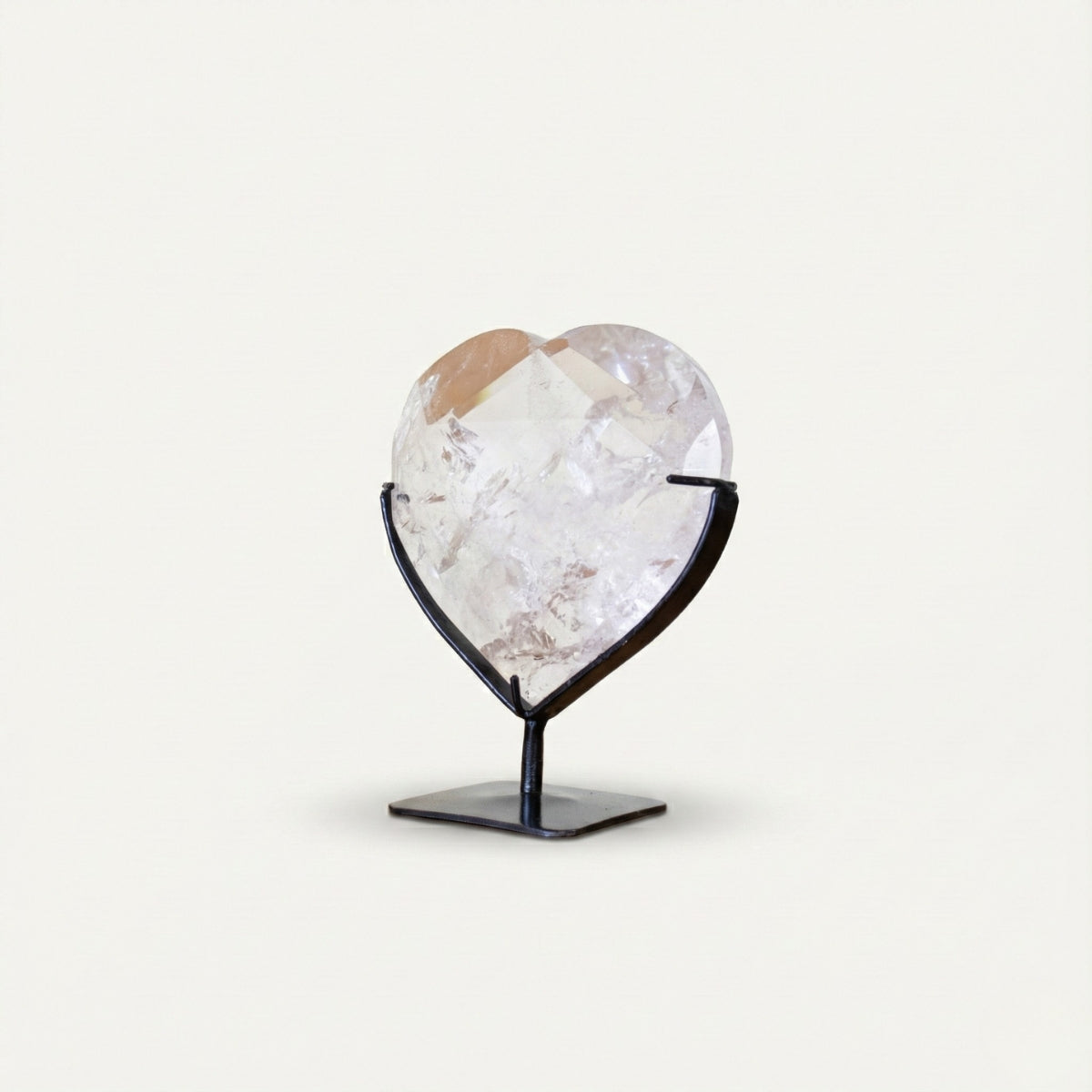 Hyaline Quartz Crystal Faceted Heart on Black Metal Base 820 grams