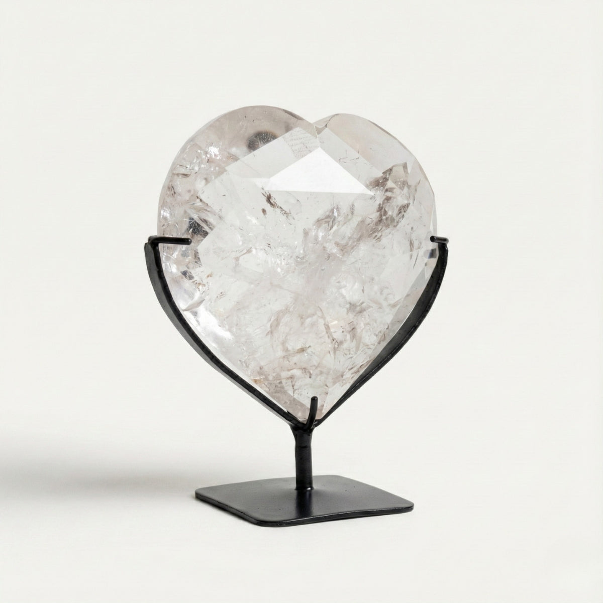 Hyaline Quartz Crystal Faceted Heart on Black Metal Base 820 grams